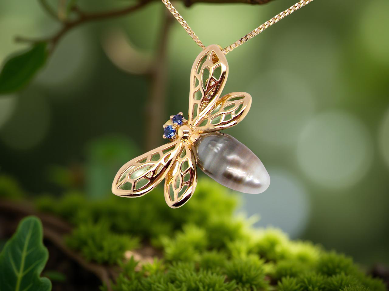double winged dragonfly. The body is a baroque shaped pearl, grey, brown to black