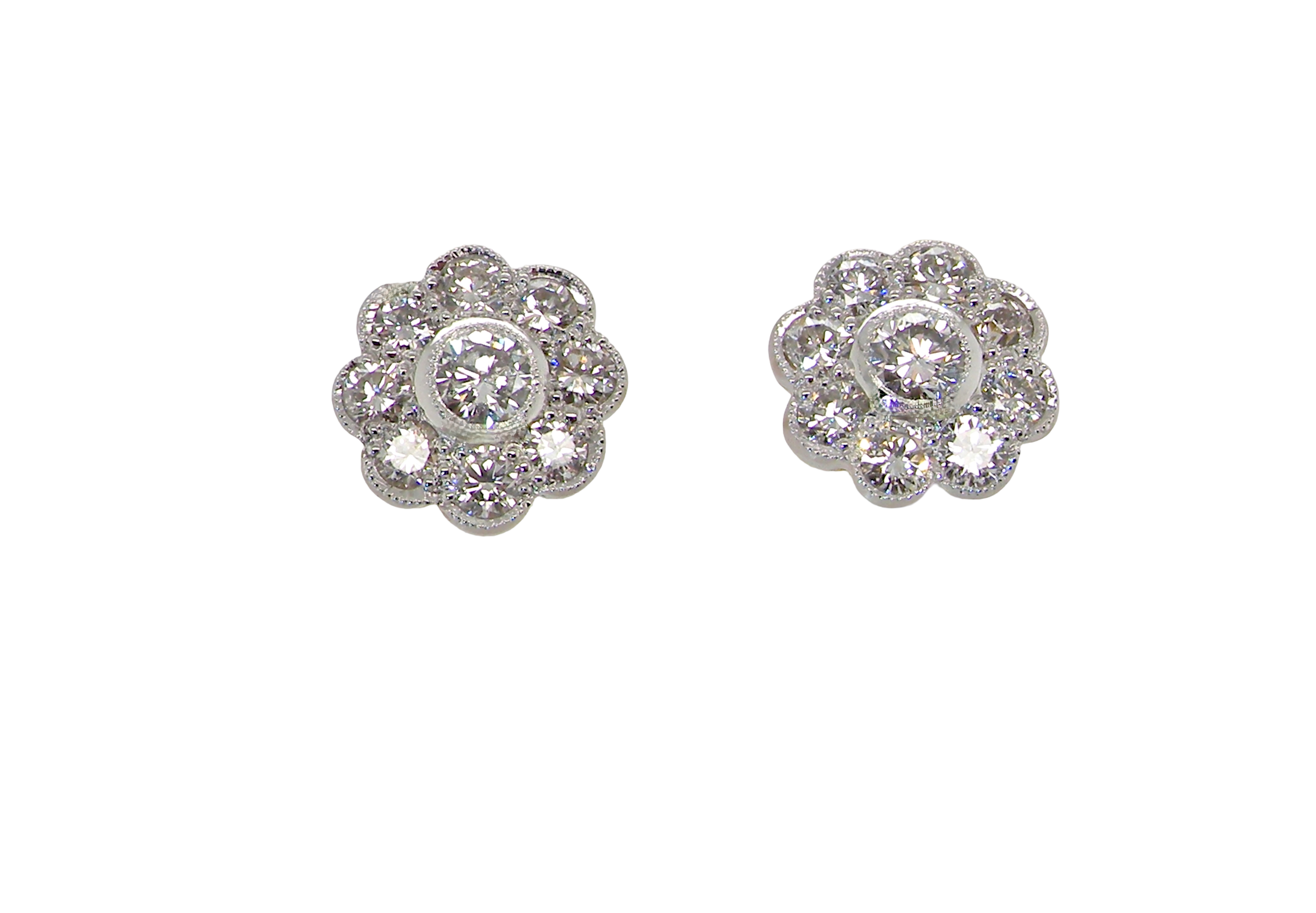 elegant pair of 18 carat gold* cluster earrings, each beautifully set with brilliant-cut white diamonds.