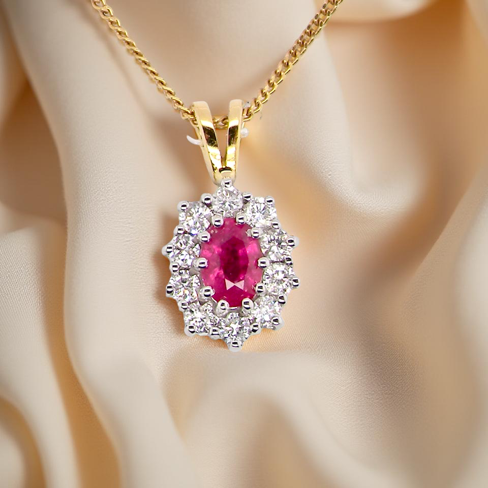 elegant pendant showcasing a vivid oval-cut red ruby