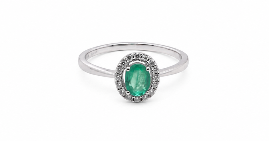 white gold ring with a green gemstone on a white background