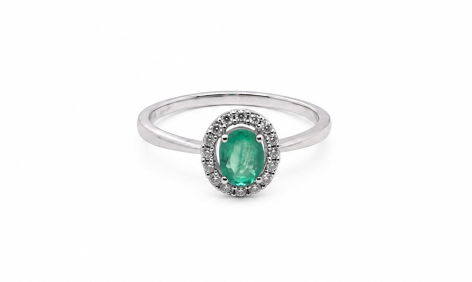 white gold ring with a green gemstone on a white background