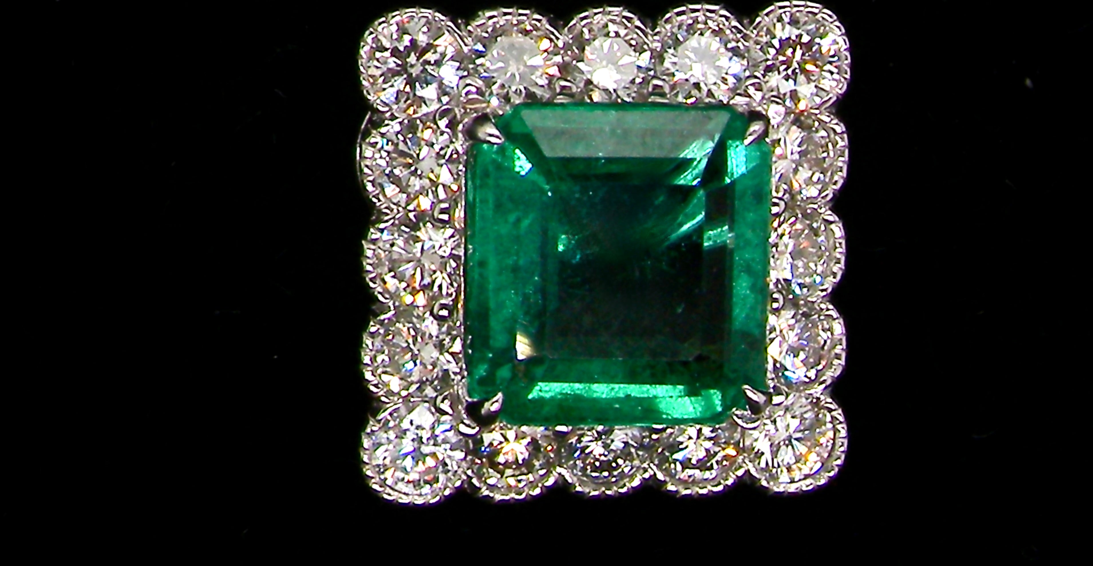 An exceptional pair of cluster earrings. Each of these beautiful earrings is set with a stunning square cut emerald, measures 7x7mm (est carat size 1.8 carats) excellent colour and clarity with just a few inclusions.