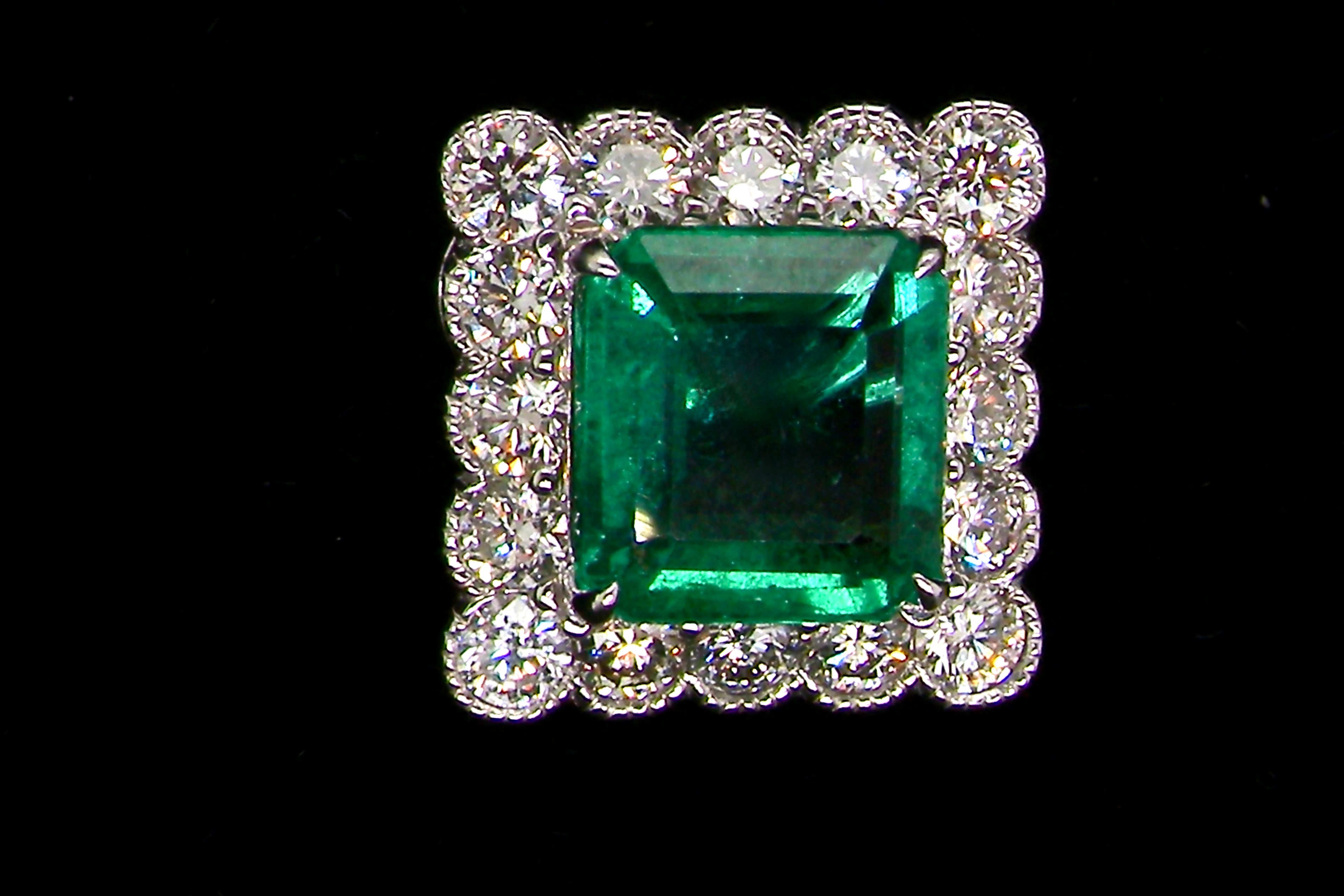 An exceptional pair of cluster earrings. Each of these beautiful earrings is set with a stunning square cut emerald, measures 7x7mm (est carat size 1.8 carats) excellent colour and clarity with just a few inclusions.