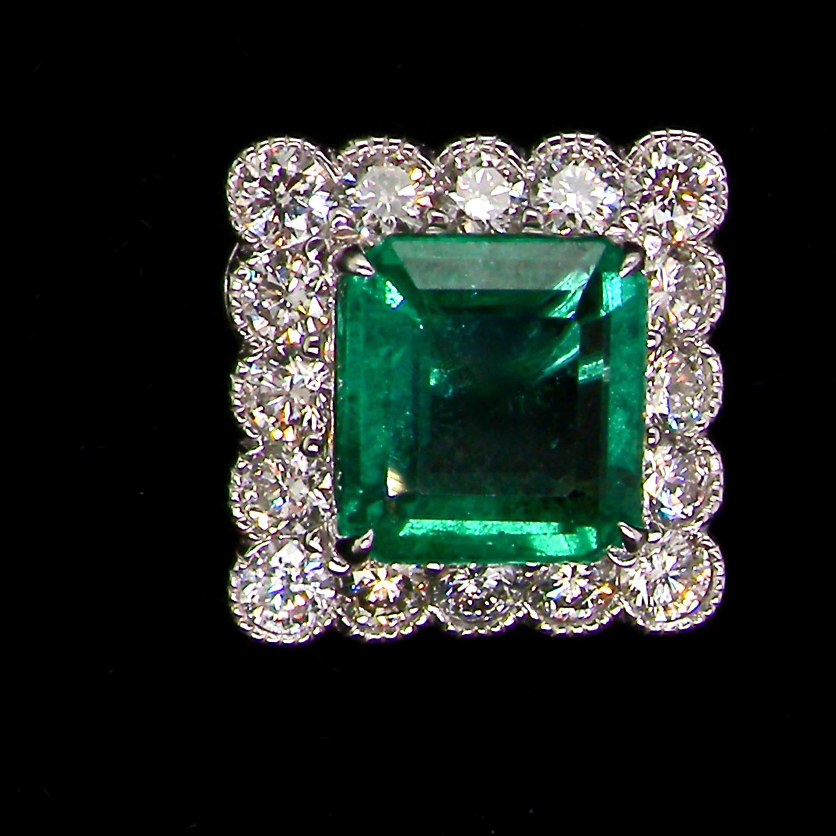 An exceptional pair of cluster earrings. Each of these beautiful earrings is set with a stunning square cut emerald, measures 7x7mm (est carat size 1.8 carats) excellent colour and clarity with just a few inclusions.