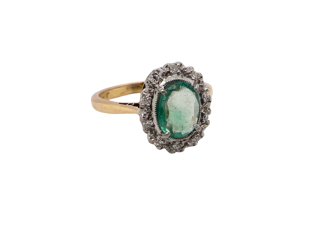 enchanting cluster ring that features at its centre an oval emerald,