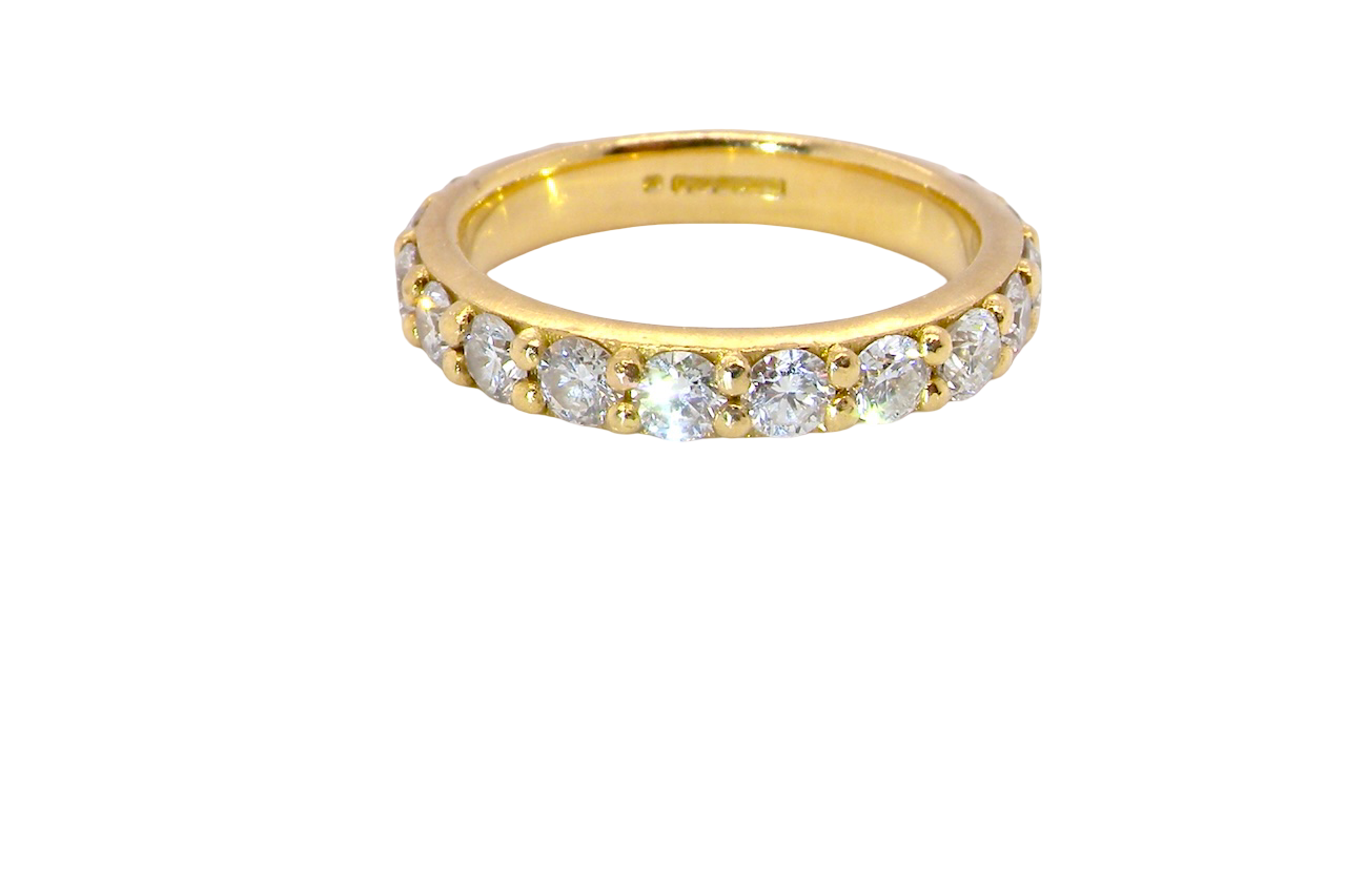 eternity ring is 18ct gold and set with fourteen round brilliant-cut white diamonds.