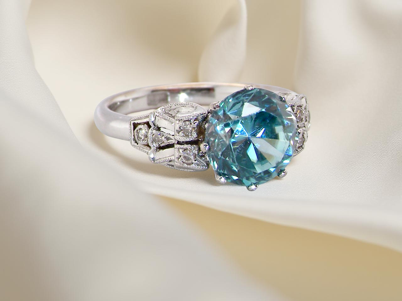 fine Art Deco ring that features a stunning natural blue zircon centre stone side