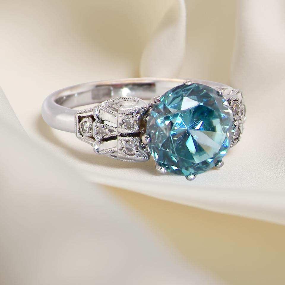 fine Art Deco ring that features a stunning natural blue zircon centre stone side