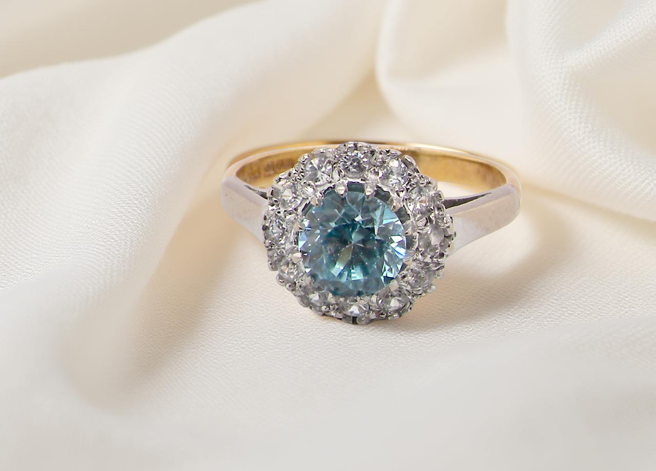 fine vintage cluster ring. The centre stone a natural blue zircon, 7mm diameter, . 