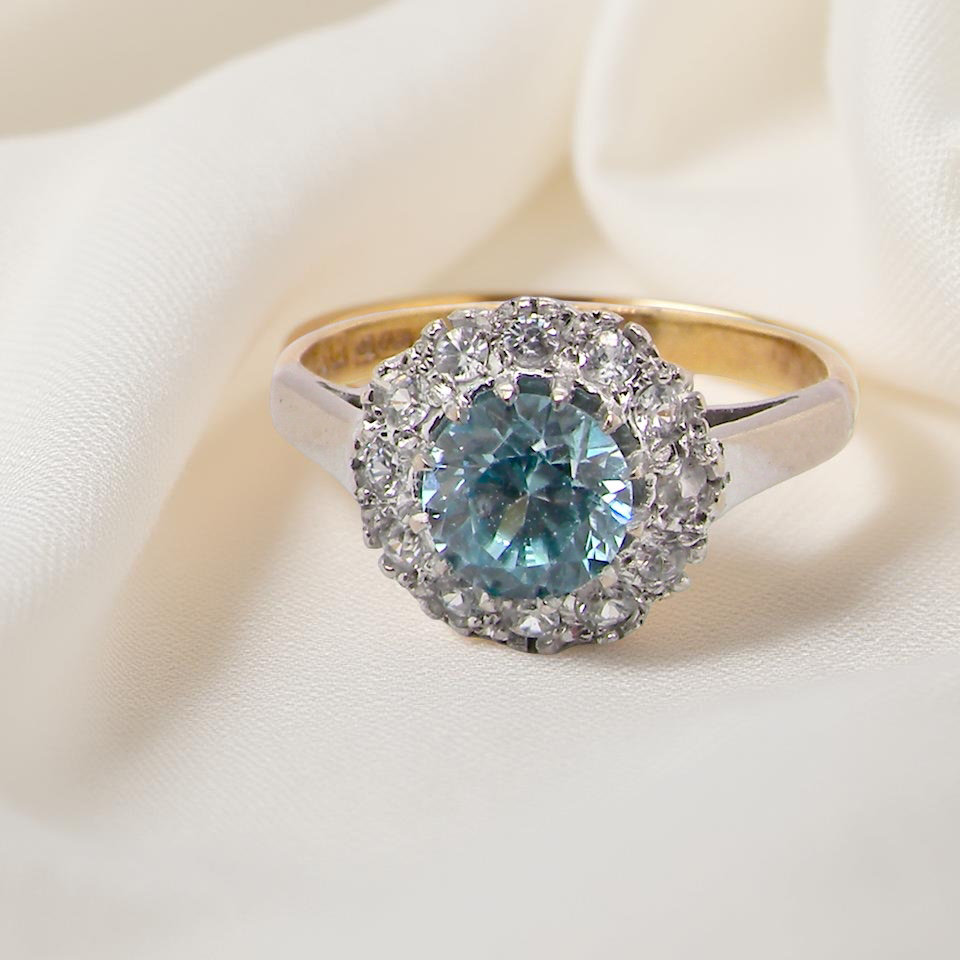 fine vintage cluster ring. The centre stone a natural blue zircon, 7mm diameter, . 