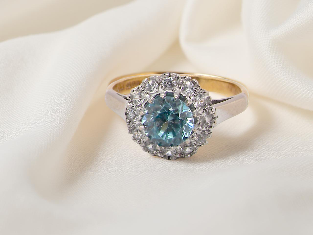 fine vintage cluster ring. The centre stone a natural blue zircon, 7mm diameter, . 