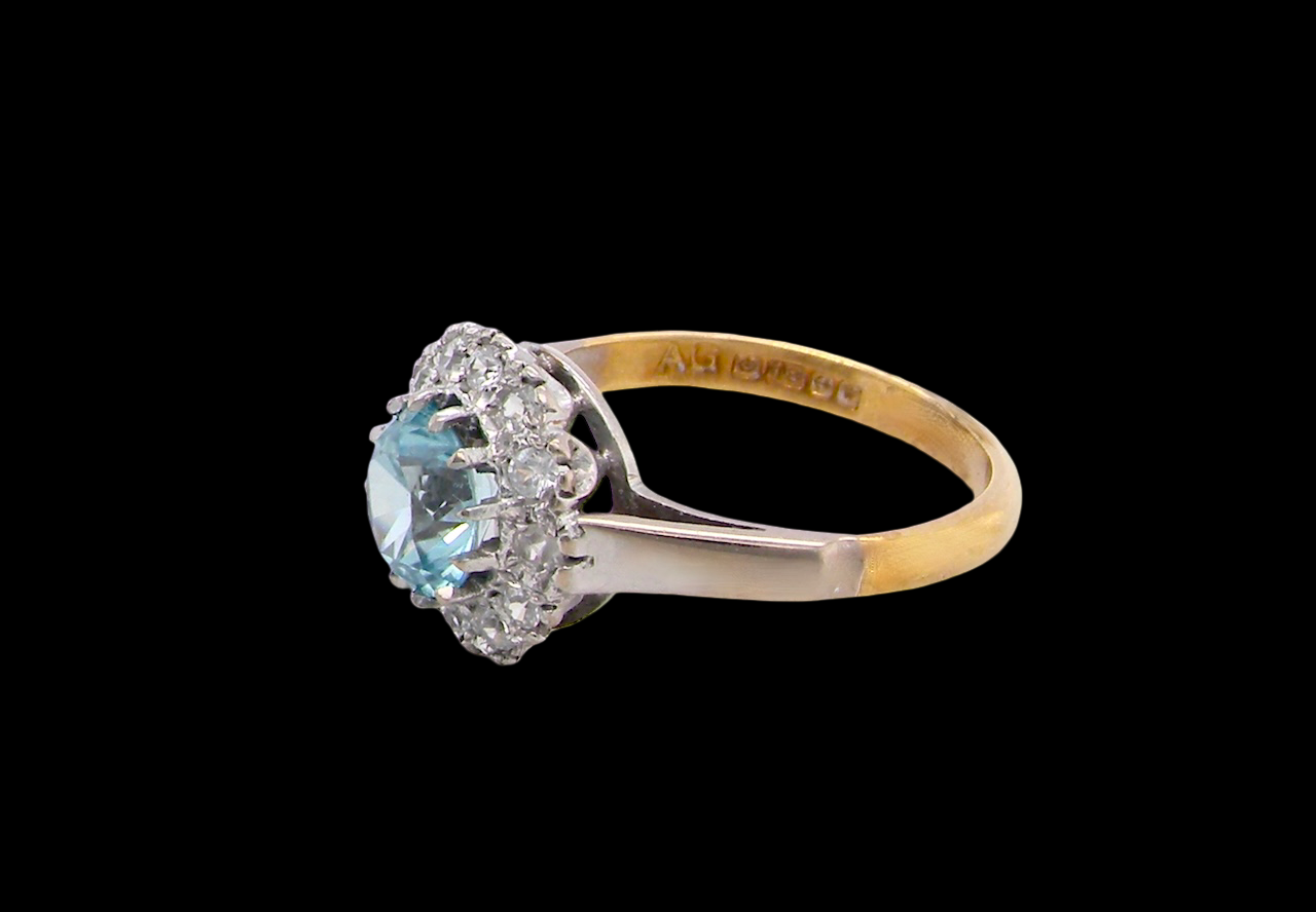 fine vintage cluster ring. The centre stone a natural blue zircon, 7mm diameter, bright sparkling refraction to the sky blue hue. side