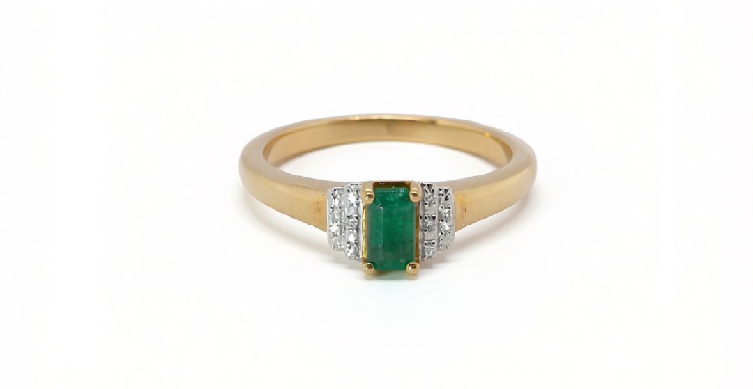 An emerald cut emerald and diamond ring