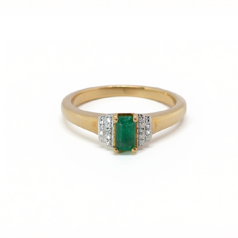 An emerald cut emerald and diamond ring