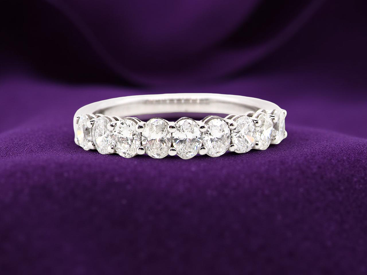 gorgeous half-hoop eternity ring set with 9 oval brilliant-cut white diamonds.