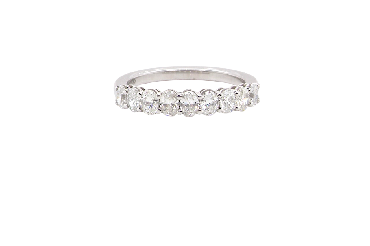 gorgeous half-hoop eternity ring set with nine oval brilliant-cut white diamonds.