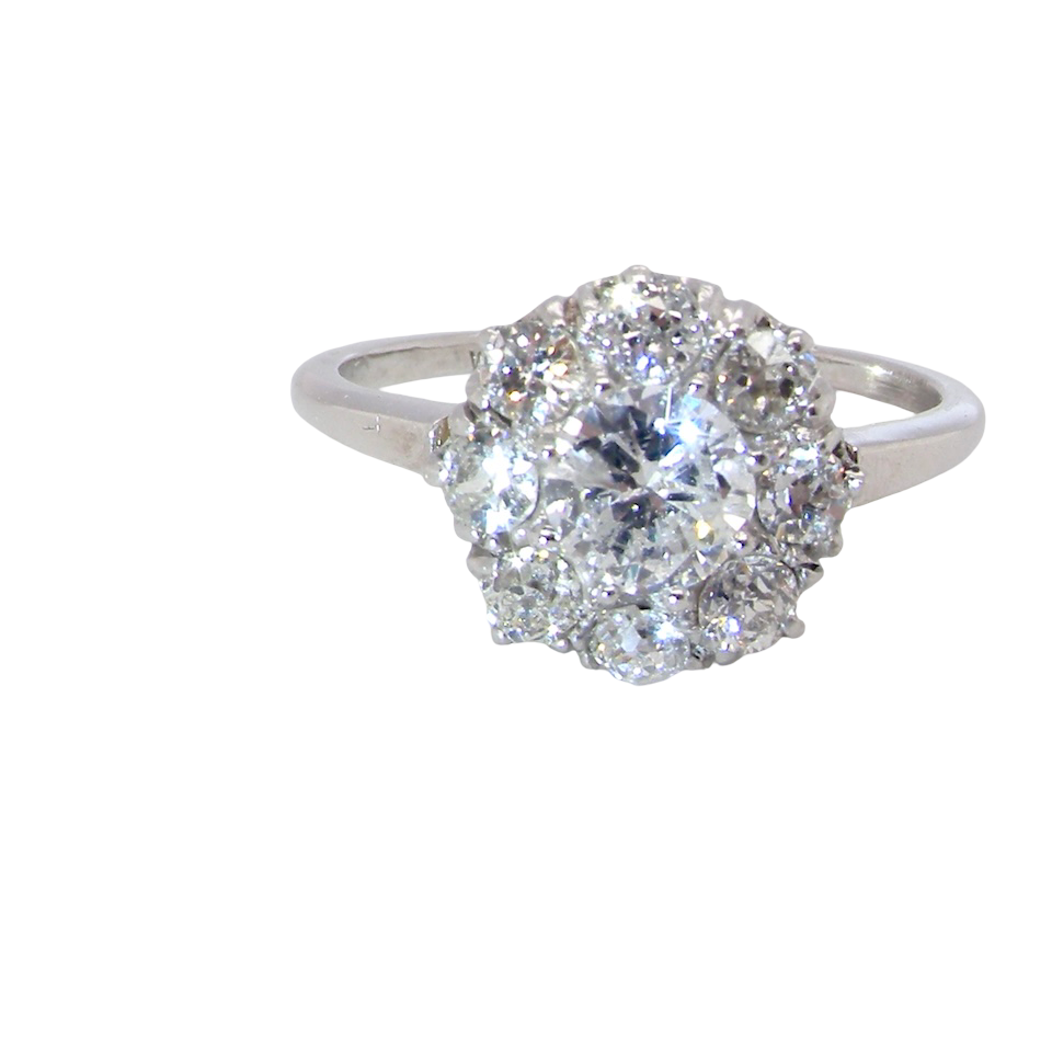 gorgeous vintage cluster ring that has as its principal setting an old brilliant cut diamond,