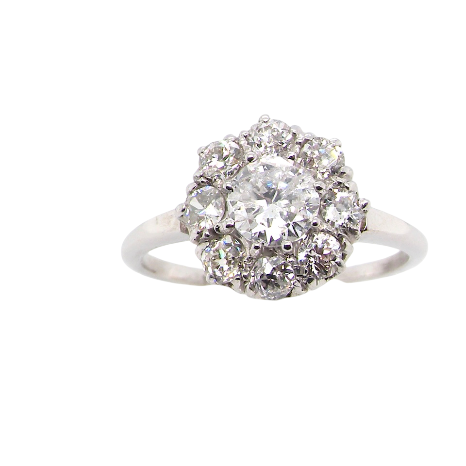 gorgeous vintage cluster ring that has as its principal setting an old brilliant cut white diamond,