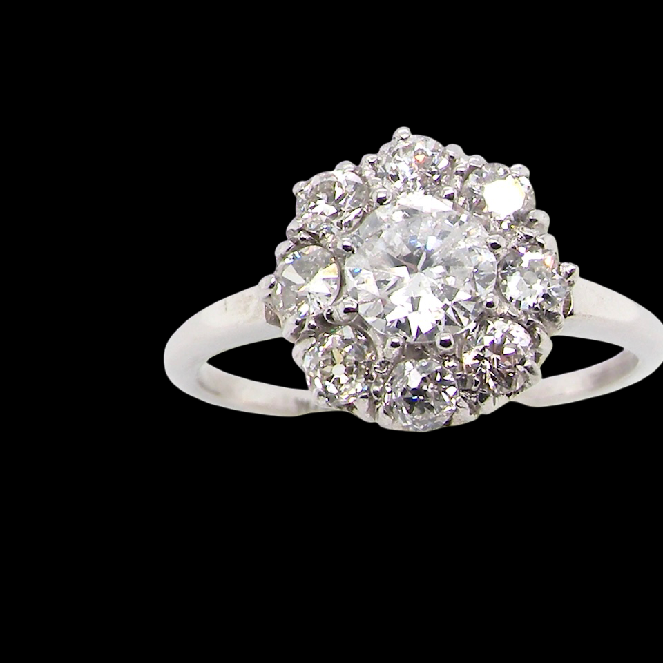 gorgeous vintage cluster ring that has as its principal setting old brilliant cut white diamond,