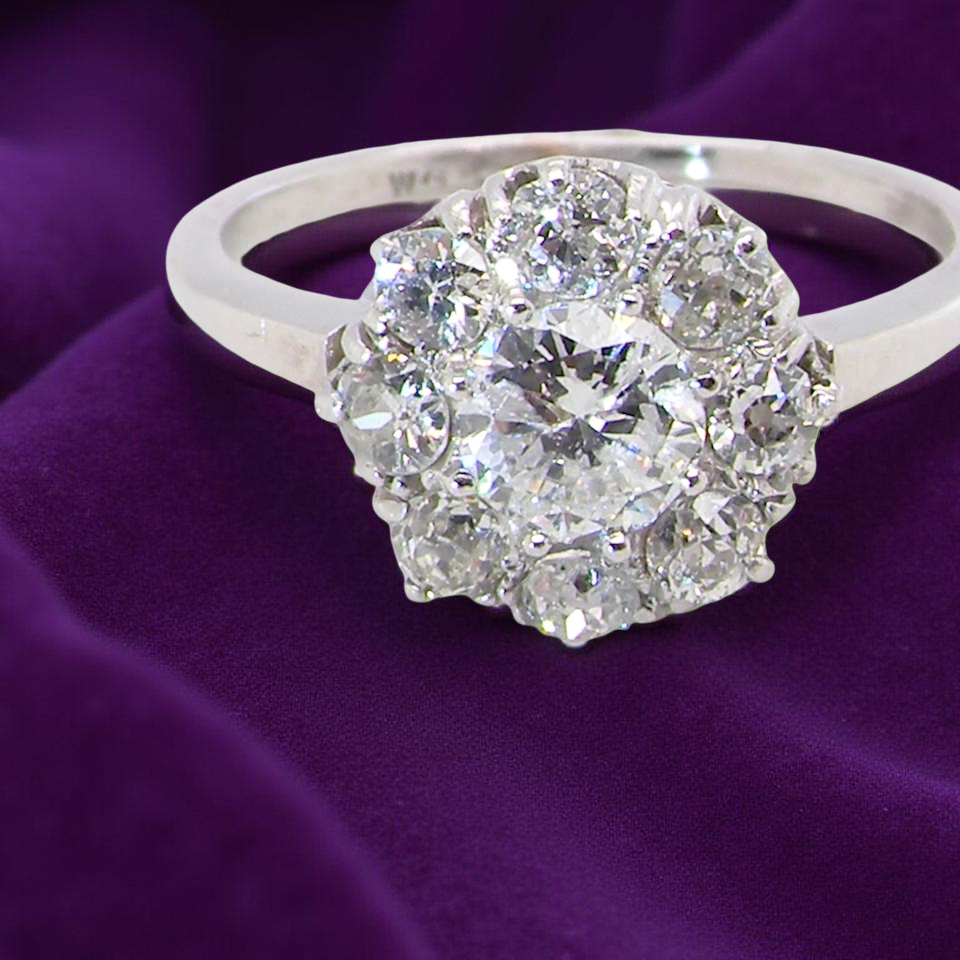 gorgeous vintage ring that has as its principal setting an old brilliant cut white diamond,