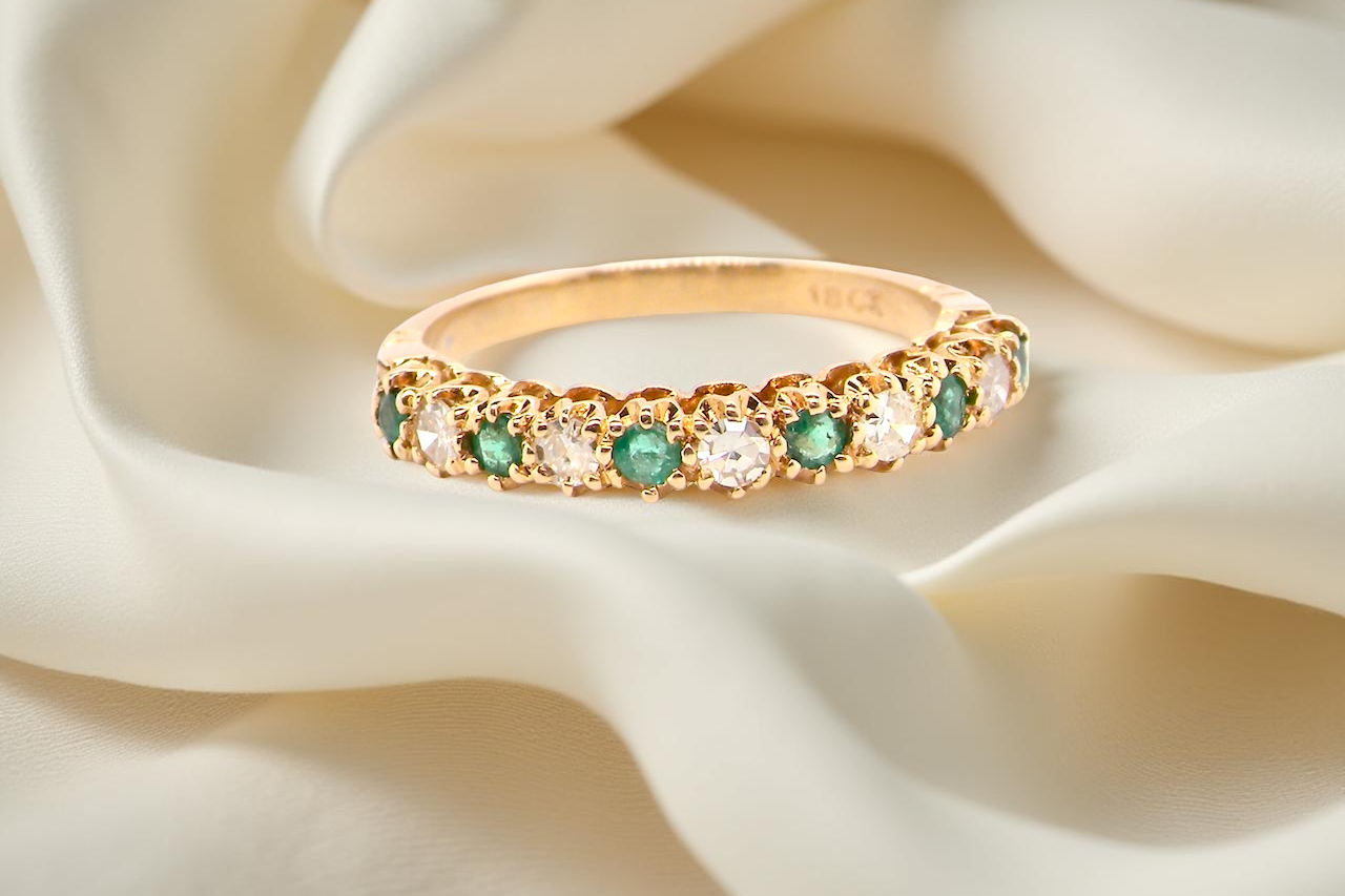half-eternity ring set alternating emeralds and diamonds.