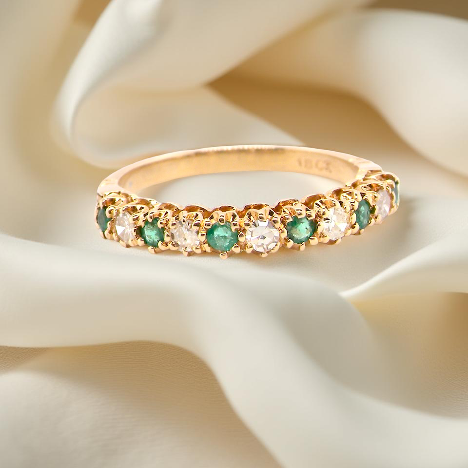 half-eternity ring set alternating emeralds and diamonds.