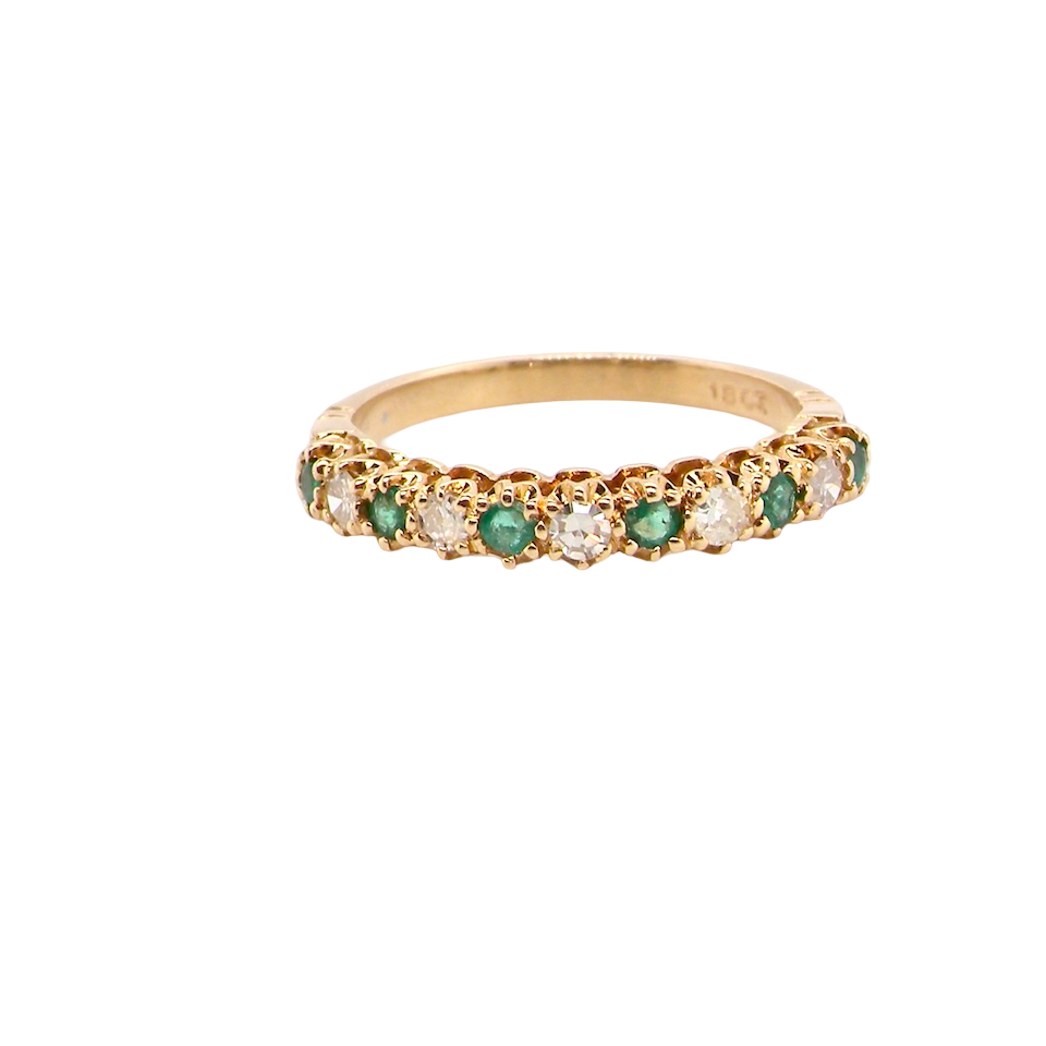 half-eternity ring set with alternating emeralds and diamonds.