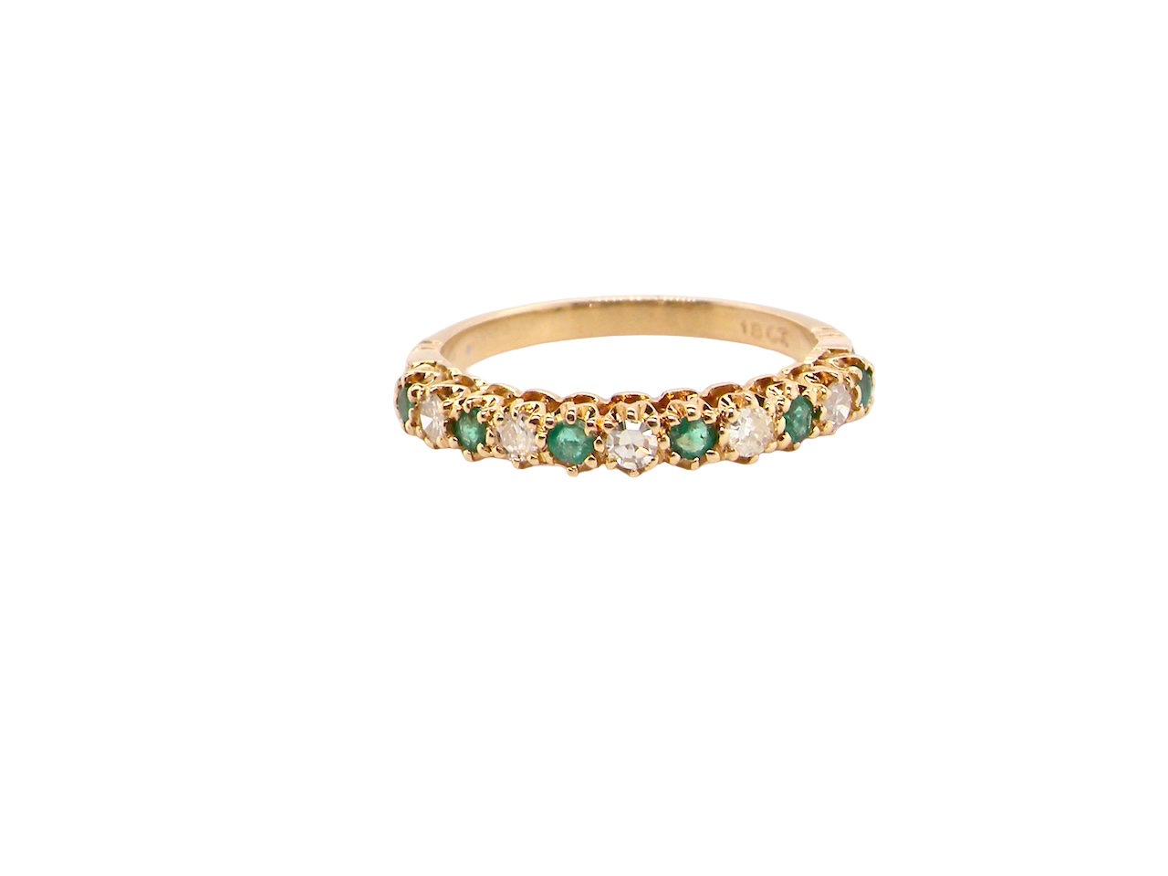 half-eternity ring set with alternating emeralds and diamonds.