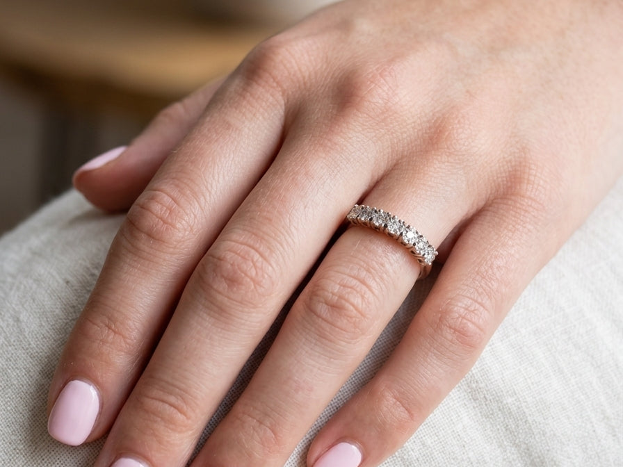 hand 9 carat gold half hoop eternity ring.
Set with seven small white diamonds, each 1.8mm within an illusion setting that is 3.8mm in diameter, and white gold. 
