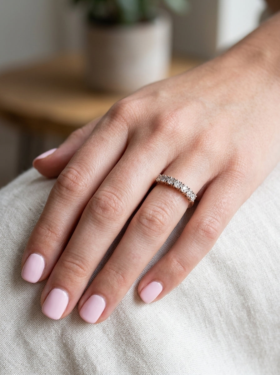 hand 9 carat gold half hoop eternity ring.
Set with seven small white diamonds, each 1.8mm within an illusion setting that is 3.8mm in diameter, and white gold. 