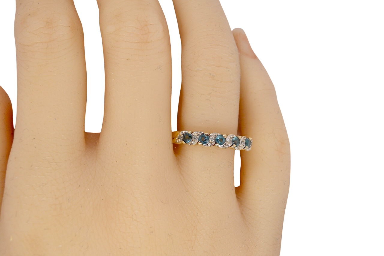 hand A 9 carat gold half hoop eternity ring. Set with five blue topaz gem stones, each 2.8mm. 