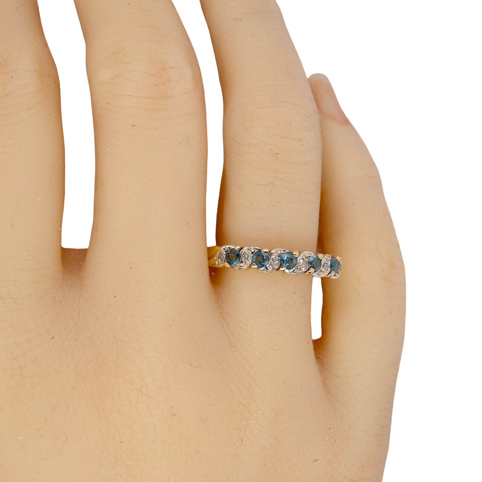 hand A 9 carat gold half hoop eternity ring. Set with five blue topaz gem stones, each 2.8mm. 