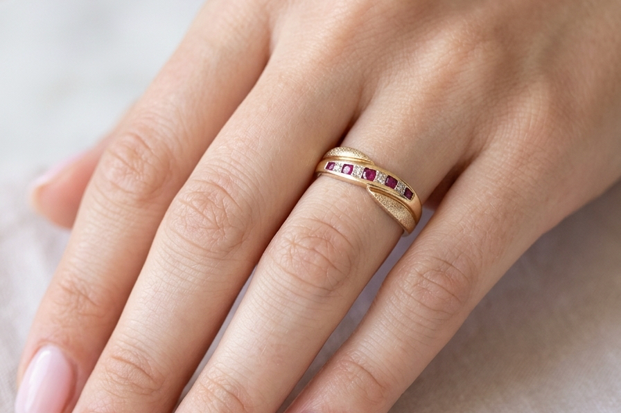 hand A 9 carat gold half hoop eternity ring. Set with five calibre cut rubies, from 1.7 to 2mm, and between small 1mm white diamonds.