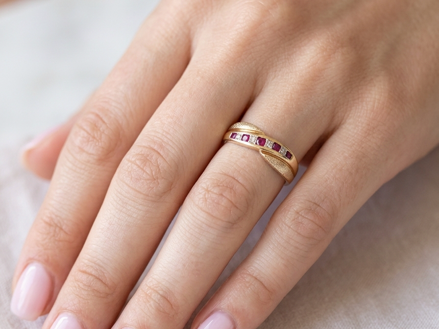 hand A 9 carat gold half hoop eternity ring. Set with five calibre cut rubies, from 1.7 to 2mm, and between small 1mm white diamonds.