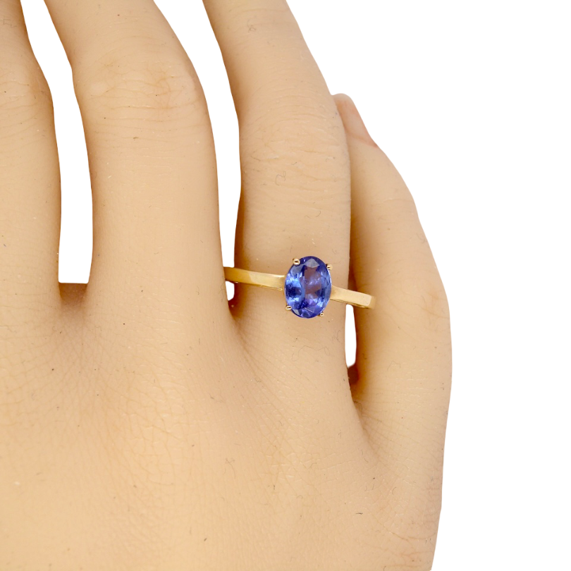 hand A 9 carat gold ring containing a single oval cut tanzanite gemstone. Measures 8x6mm, four claw setting.