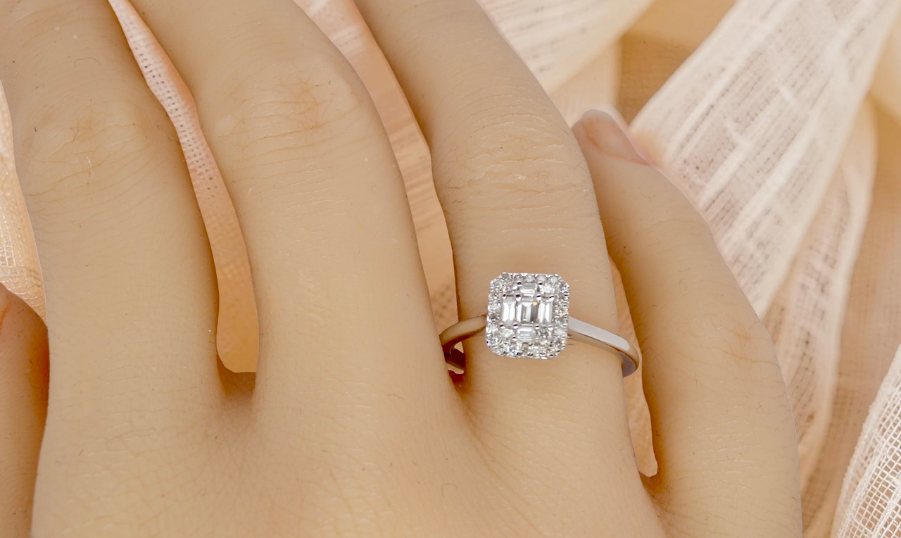 hand A 9 carat white gold cluster ring. The centre is set with five baguette cut white diamonds, 3 x 2x1.2mm, 2 x 1mm.