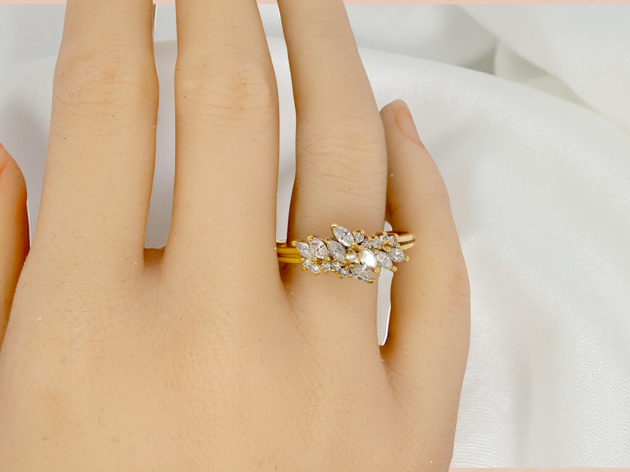 Gold ring with diamonds on a hand against a white background
