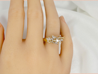 Gold ring with diamonds on a hand against a white background
