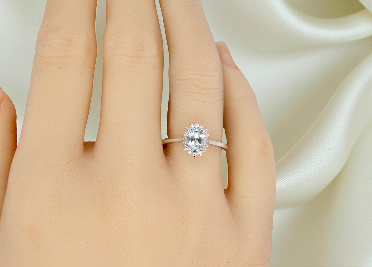 A NEW blue topaz and diamond ring