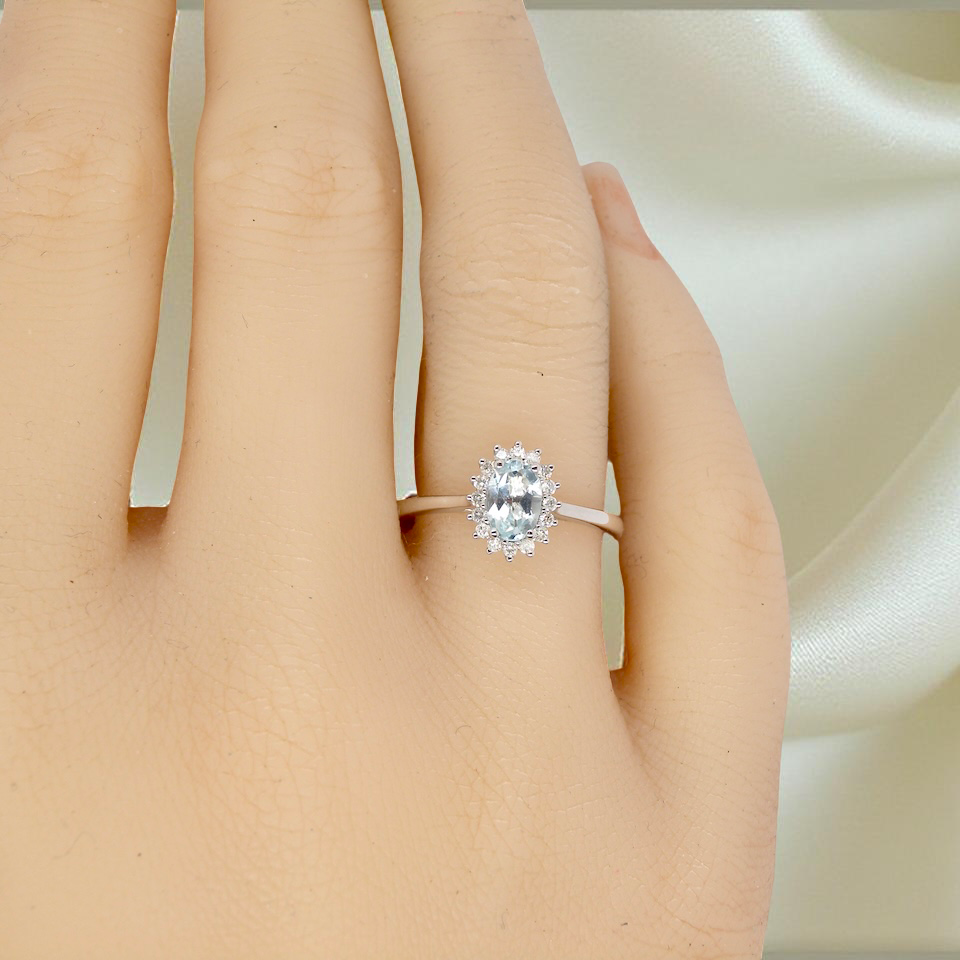A NEW blue topaz and diamond ring