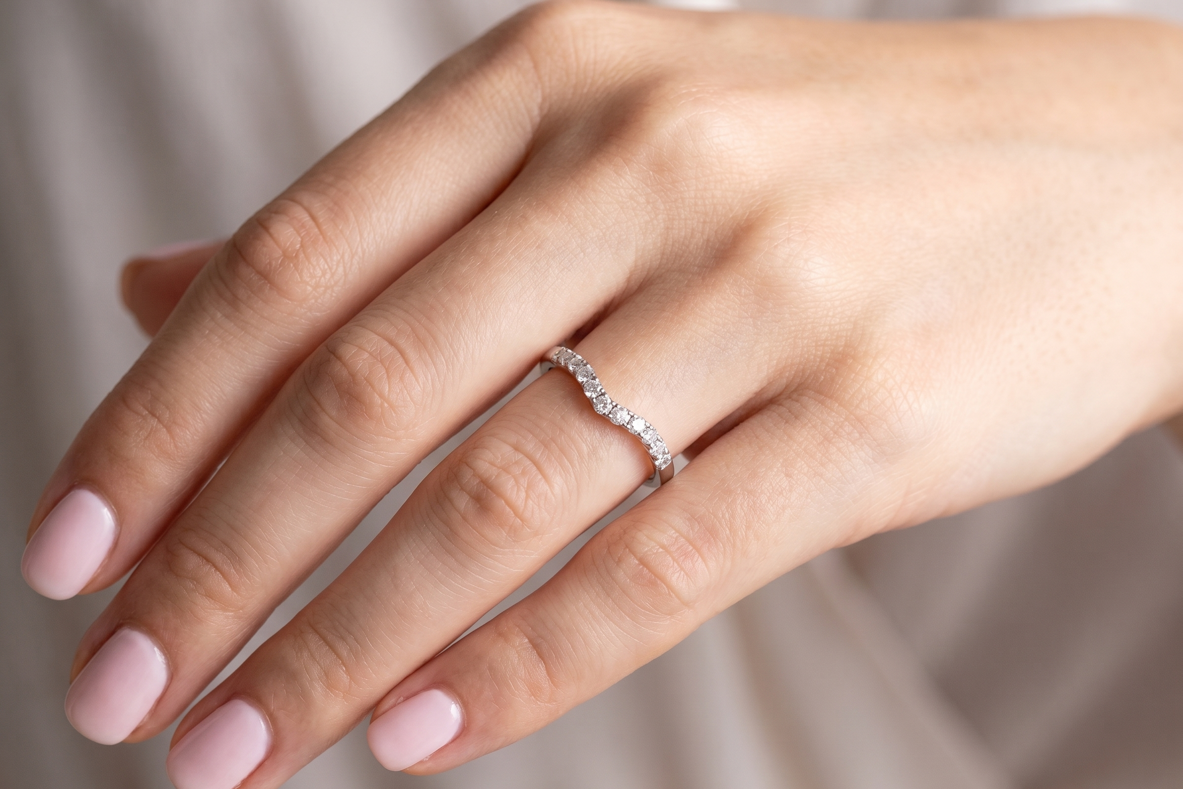 hand A Platinum half hoop ring featuring a gently contoured U-shaped centre, designed to allow a cluster or solitaire ring to sit comfortably alongside.