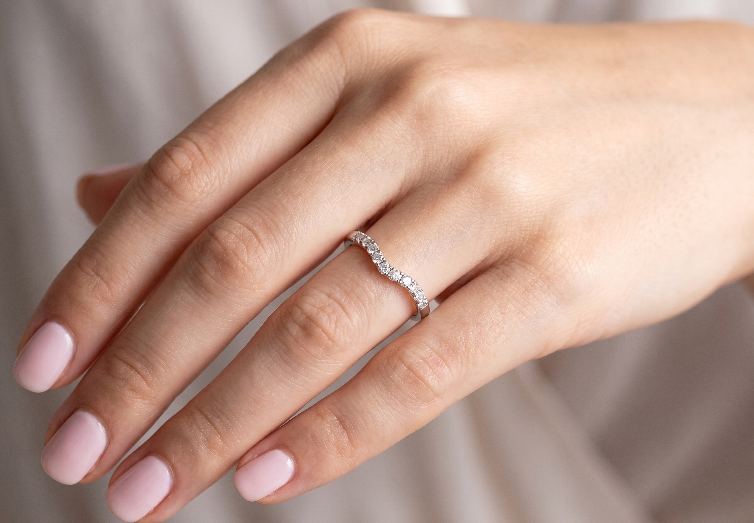 hand A Platinum half hoop ring featuring a gently contoured U-shaped centre, designed to allow a cluster or solitaire ring to sit comfortably alongside.