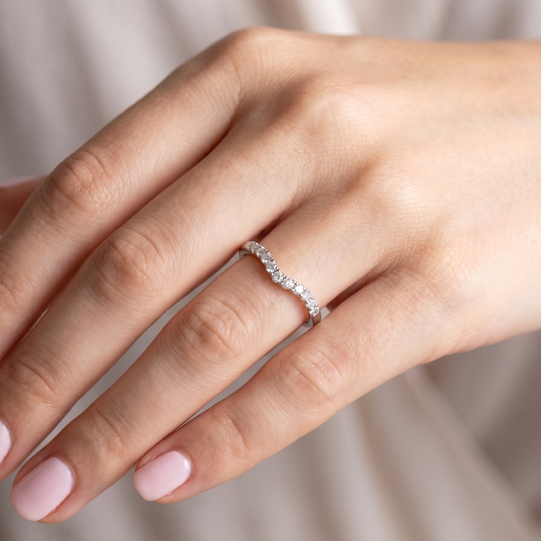 hand A Platinum half hoop ring featuring a gently contoured U-shaped centre, designed to allow a cluster or solitaire ring to sit comfortably alongside.