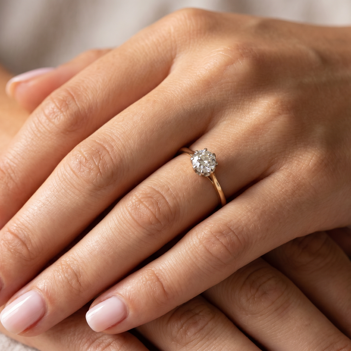 hand A beautiful vintage diamond solitaire ring featuring an old brilliant cut white diamond measuring approximately 6mm, estimated at 0.75 carats. The diamond displays attractive sparkle with an assessed colour of I–J and clarity of SI.