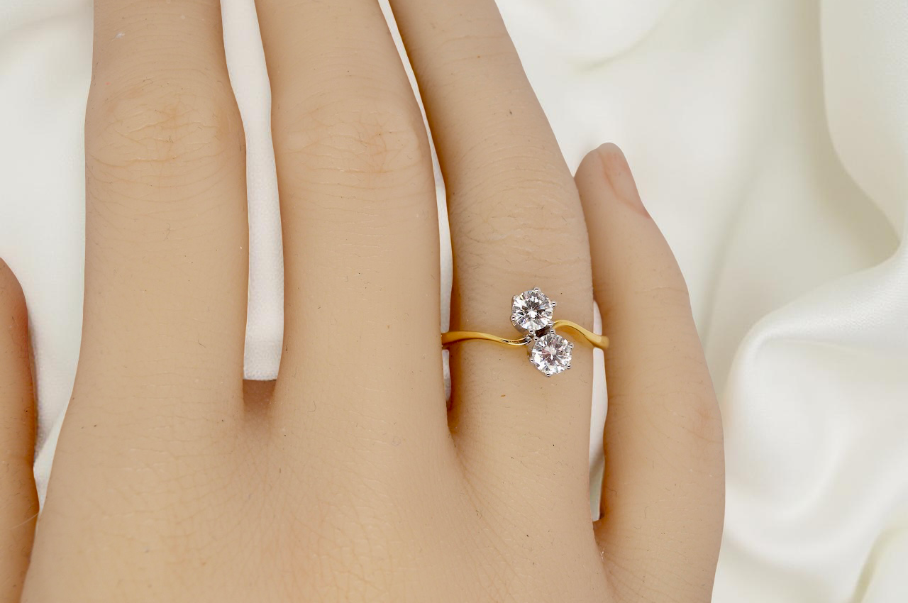 hand A beautifully balanced Moi et Toi ring featuring two sparkling modern brilliant-cut diamonds