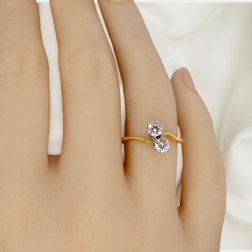hand A beautifully balanced Moi et Toi ring featuring two sparkling modern brilliant-cut diamonds