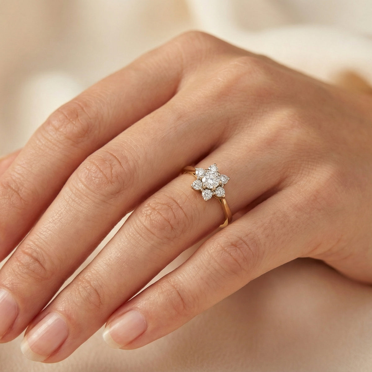 hand A beautifully crafted vintage diamond cluster ring, dating to the 1960s, featuring a classic floral-inspired design that remains timeless and elegant.