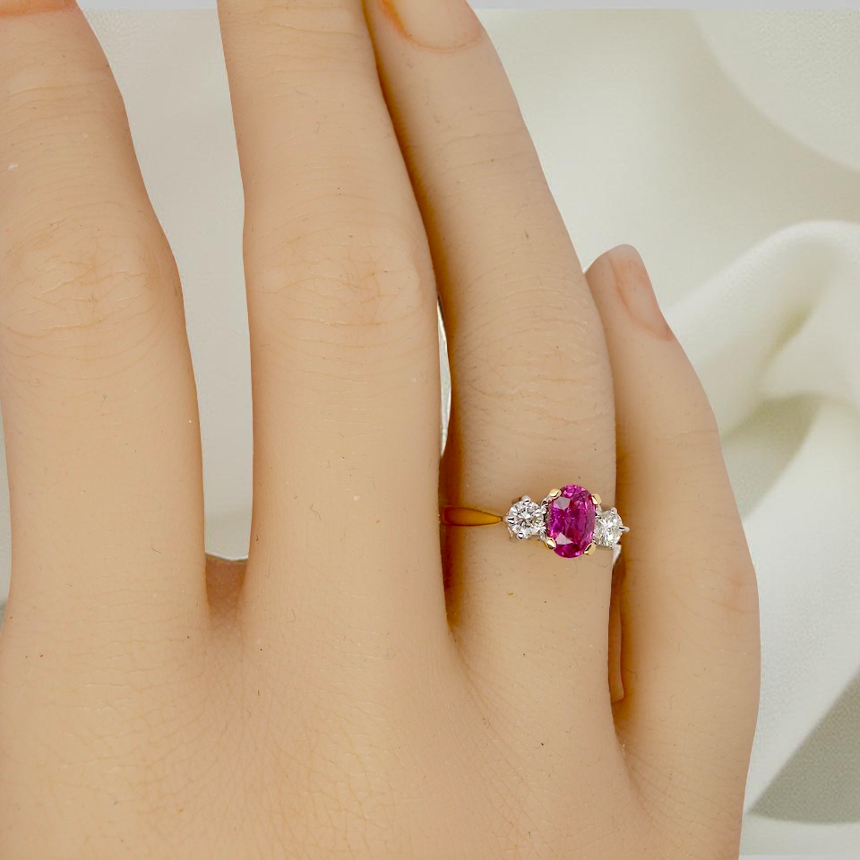 hand A beautifully crafted vintage ruby trilogy ring in rich 18-carat gold