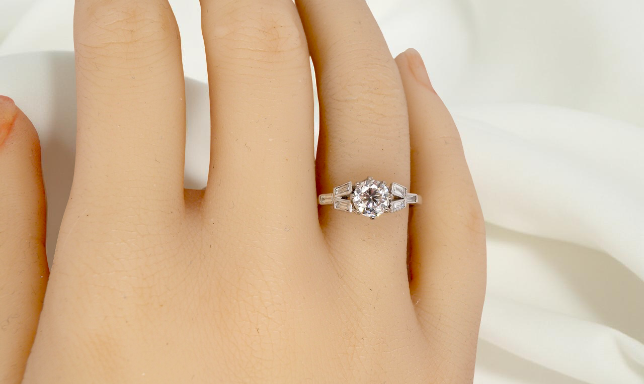 hand A beautifully proportioned Art Deco solitaire ring showcasing a sparkling old brilliant cut white diamond