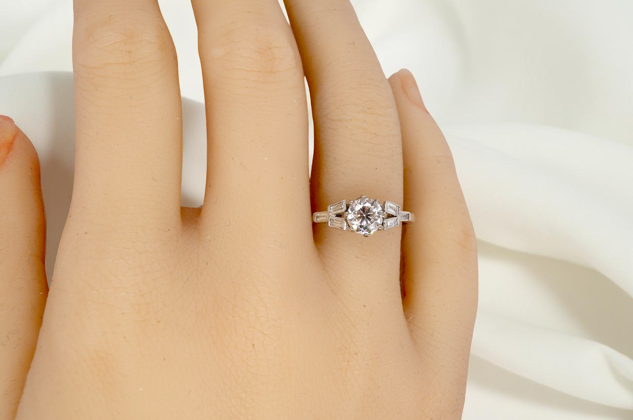 hand A beautifully proportioned Art Deco solitaire ring showcasing a sparkling old brilliant cut white diamond